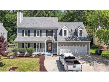 Charming two-story home featuring a well-manicured lawn, two-car garage, and welcoming front porch at 4309 Birmingham Way, Raleigh, NC 27604