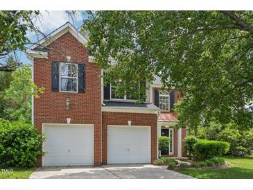 Charming two-story brick home features a two-car garage and manicured landscaping at 510 N Waters Edge Dr, Durham, NC 27703