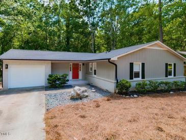 Charming single-story home with a red front door, gray siding, and well-maintained landscaping at 801 Madison Ave, Cary, NC 27513