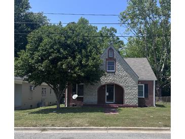 Charming stone and brick home with mature tree, arched entry, and well-maintained lawn at 808 Belvedere St, Rocky Mount, NC 27803