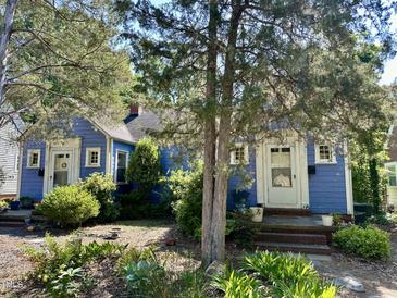 Charming blue house featuring a landscaped front yard and inviting front porch at 1012 Virgie St, Durham, NC 27705