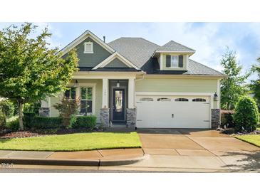 Charming two-story home with a manicured lawn and two car garage, showing great curb appeal at 108 Boone St, Chapel Hill, NC 27516
