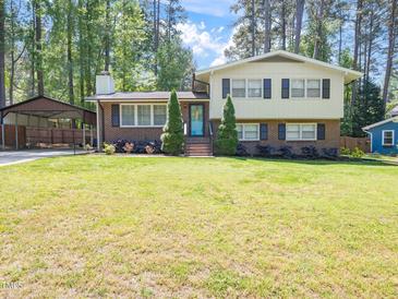 Charming two-story home with brick facade and a well-manicured lawn at 1103 Brucemont Dr, Garner, NC 27529