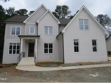 Stunning two-story white brick home with detailed trim and an inviting front porch at 1444 Old Apex Rd, Cary, NC 27513