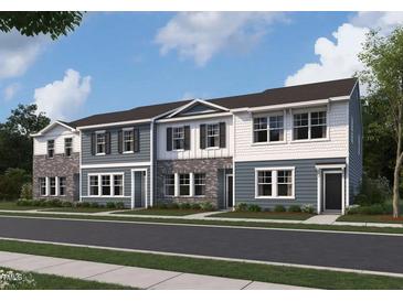 Charming townhome exterior showcasing a blend of textures and colors with well-manicured landscaping at 2109 Glen Crossing Dr, Durham, NC 27704