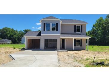 New two-story home with a two-car garage and lovely landscaping on a sunny day at 2535 Whitetail Rd, Nashville, NC 27856