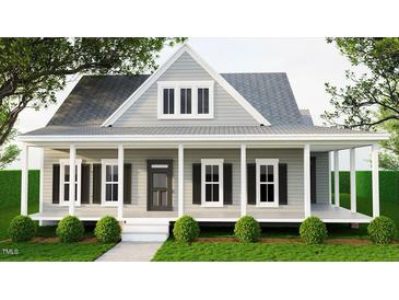 Charming home with a covered porch, black shutters, and well-manicured landscaping at 328 Green Pines Estates Dr, Kenly, NC 27542