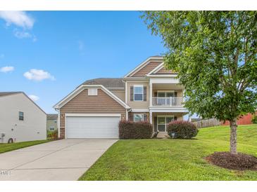 Charming two-story home with a two car garage, balcony, and manicured lawn at 3832 Stovall Dr, Haw River, NC 27258