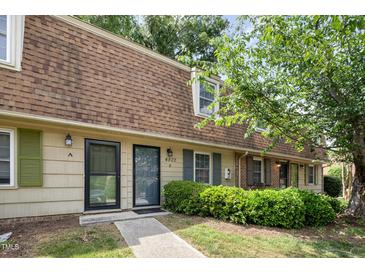 Charming townhome featuring a distinctive brown roof, tidy landscaping, and a welcoming entrance at 4822 Blue Bird Ct # B, Raleigh, NC 27606