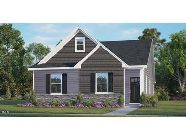 Charming two-story home boasts a mix of gray siding, stone accents, and a well-manicured front lawn at 600 Sweet Iris Dr, Knightdale, NC 27545