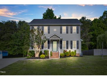 Charming two-story home with gray siding, black shutters, and manicured front yard at 827 Lockesley Ln, Burlington, NC 27217