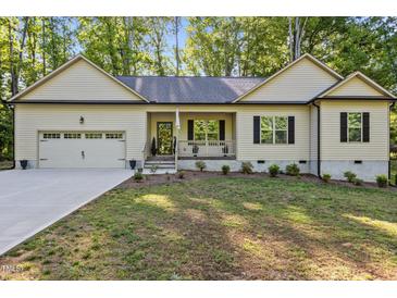 Charming single-story home featuring a well-manicured lawn, attached garage, and covered porch at 105 Oak Ridge Rd, Franklinton, NC 27525