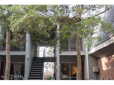 Exterior showcases multi-level condo with open staircases, brick accents, and mature landscaping at 108 Ephesus Church Rd # Apt 416, Chapel Hill, NC 27517