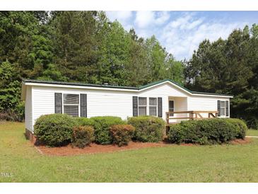 Charming single-story home with manicured landscaping and a cozy front deck at 1201 Red Sunset Pl, Siler City, NC 27344