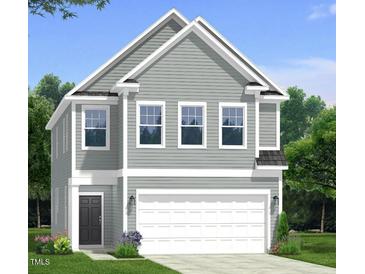 Charming two-story home featuring gray siding, white trim, and an attached two-car garage at 195 Steel Spring Ln # 20, Angier, NC 27501
