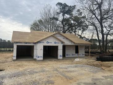 Image displays new construction of a single-story home with an attached two-car garage, awaiting finishing touches at 2555 Whitetail Rd, Nashville, NC 27856