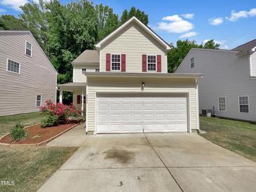 Charming two-story home with a two car garage, red shutters, and well-maintained landscaping at 3223 Polite Ln, Raleigh, NC 27610