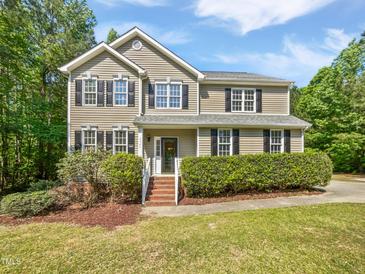 Charming two-story home featuring black shutters and a manicured front yard with mature landscaping at 3705 Cassaro Ln, Zebulon, NC 27597
