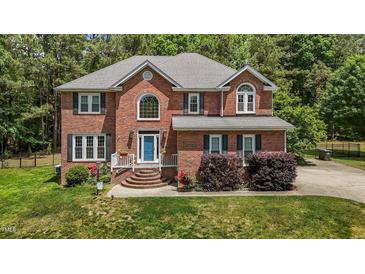 Charming brick home featuring a well-manicured lawn and inviting front entrance at 4225 Old Lewis Farm Rd, Raleigh, NC 27604