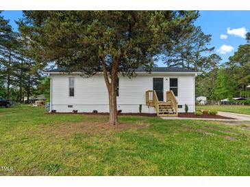 Charming, well-maintained house featuring vinyl siding, new front steps, and a lovely landscaped yard at 623 Lincoln Dr, Kenly, NC 27542