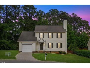 Charming two-story home featuring well-manicured lawn and attached garage, perfect curb appeal at 8004 Mill Bluff Ct, Raleigh, NC 27616