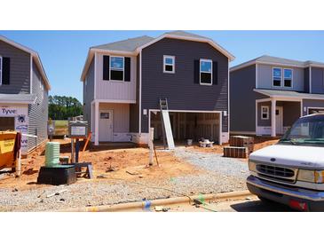 New two-story home under construction with dark siding and a two-car garage ready for customization at 805 Ottawa Dr, Garner, NC 27529