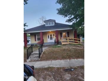Charming single-story home featuring a peaked roof, decorative dormer, and inviting front porch with ramp access at 1007 Grace Ave, Burlington, NC 27217