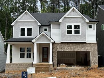 New construction with brick foundation, gray siding, and an attached 2-car garage at 118 Sanderway Dr, Chapel Hill, NC 27516