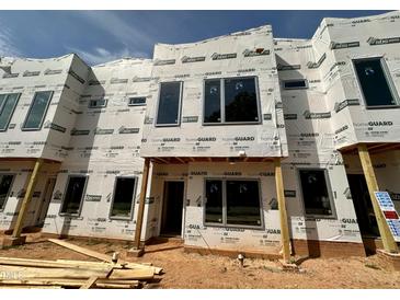 New construction townhome featuring modern architectural details, large windows, and durable weather-resistant wrap at 1523 Sunrise Ave, Raleigh, NC 27608