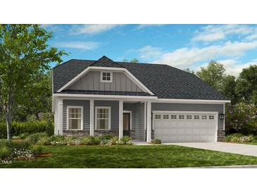 Charming one-story home featuring stone accents, well-manicured lawn, and a two-car garage at 2000 Clydner Dr, Apex, NC 27523