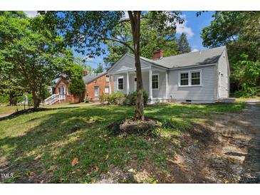 Charming single-story home with a welcoming front porch and mature trees in a residential neighborhood at 2206 Guess Rd, Durham, NC 27705