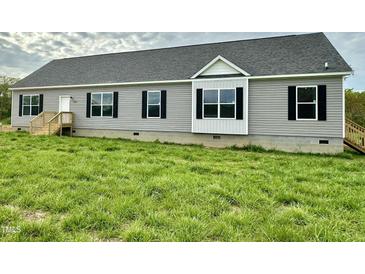 Charming single-story home features gray siding, black shutters, and a well-maintained green lawn at 2912 Epps Clark Rd, Siler City, NC 27344