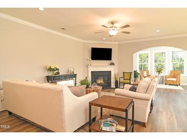 Inviting living room featuring a cozy fireplace and plenty of natural light from a large window at 3006 Dog Rose Dr # 308, Durham, NC 27703