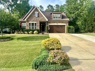 Charming stone-accented home with a well-manicured lawn and inviting curb appeal at 4405 Brighton Ridge Dr, Apex, NC 27539