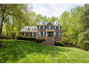 Beautiful brick home with dormer windows and a well-manicured lawn at 5025 Martin Farm Rd, Raleigh, NC 27613