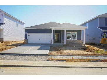 Charming single-story home featuring a two-car garage, vinyl siding, and a welcoming front entrance at 648 White Birch Ln, Angier, NC 27501