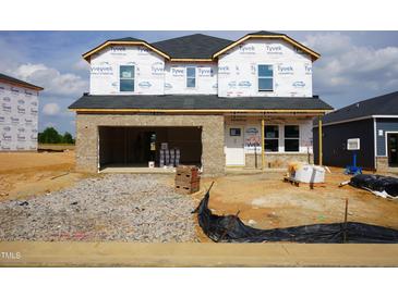 New construction home featuring brick facade and an attached garage ready for customization and personalization at 658 White Birch Ln, Angier, NC 27501