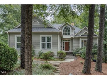 Charming home featuring light gray siding, a dark roof, and a beautiful arched window over the front door at 81008 Alexander, Chapel Hill, NC 27517
