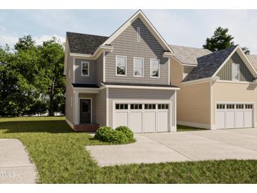 Charming two-story home featuring gray siding, black roof, and a two-car attached garage at 1036 Harper Rd, Raleigh, NC 27603