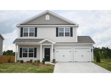 Charming two-story home with a two-car garage, black shutters, and landscaping at 1036 Thicket Dr # 221, Burlington, NC 27217