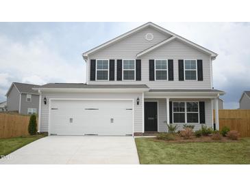Charming two-story home with light grey siding, black shutters, and a spacious two-car garage at 1069 Thicket Dr # 355, Burlington, NC 27217