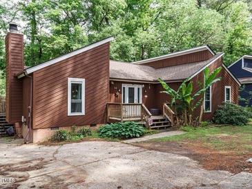 Charming brown two-story home featuring a chimney and a quaint front porch entrance at 112 Cameron Ct, Cary, NC 27511