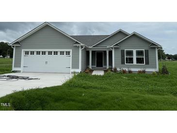 Charming single-Gathering home with gray siding, a two-car garage, and a well-maintained lawn at 167 Lotus Ave, Smithfield, NC 27577