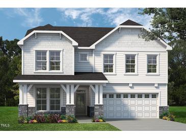 Charming two-story home with white siding, stone accents, and a welcoming covered porch at 1931 Ballard Rd, Fuquay Varina, NC 27526