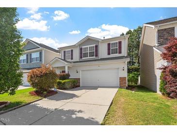 Charming two-story home with a two-car garage and well-maintained landscaping at 208 Station Dr, Morrisville, NC 27560