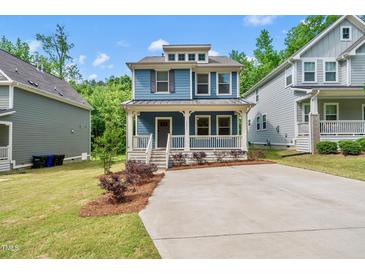 Charming two-story home with a welcoming front porch and well-maintained landscaping at 2407 Miriam Cir, Durham, NC 27704