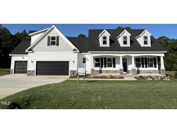 Inviting curb appeal with stone accents and a well-maintained lawn at 253 Busterfield Ct, Benson, NC 27504