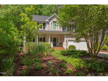 Charming two-story home with manicured landscaping, inviting front porch, and attached two car garage at 401 Robert Hunt Dr, Carrboro, NC 27510