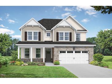 Charming two-story home with stone accents, manicured lawn, and attached two car garage at 416 Longleaf Glen Ln, Zebulon, NC 27597
