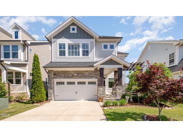 Charming two-story home with a stone-accented facade, attached garage, and manicured landscaping at 79 Tarwick Ave, Chapel Hill, NC 27516